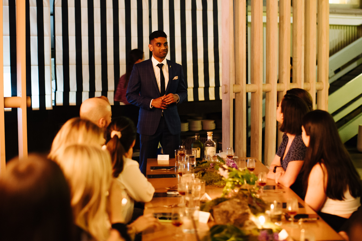 Diplomatico brand ambassador talks to guest seated for the event, with diplomatico and canaima bottlings on show